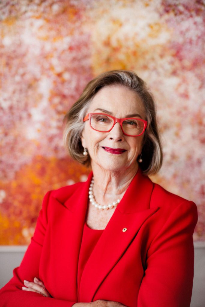 portrait of Wendy McCarthy in striking red