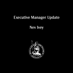 Young person wearing blue cap reading book outdoors