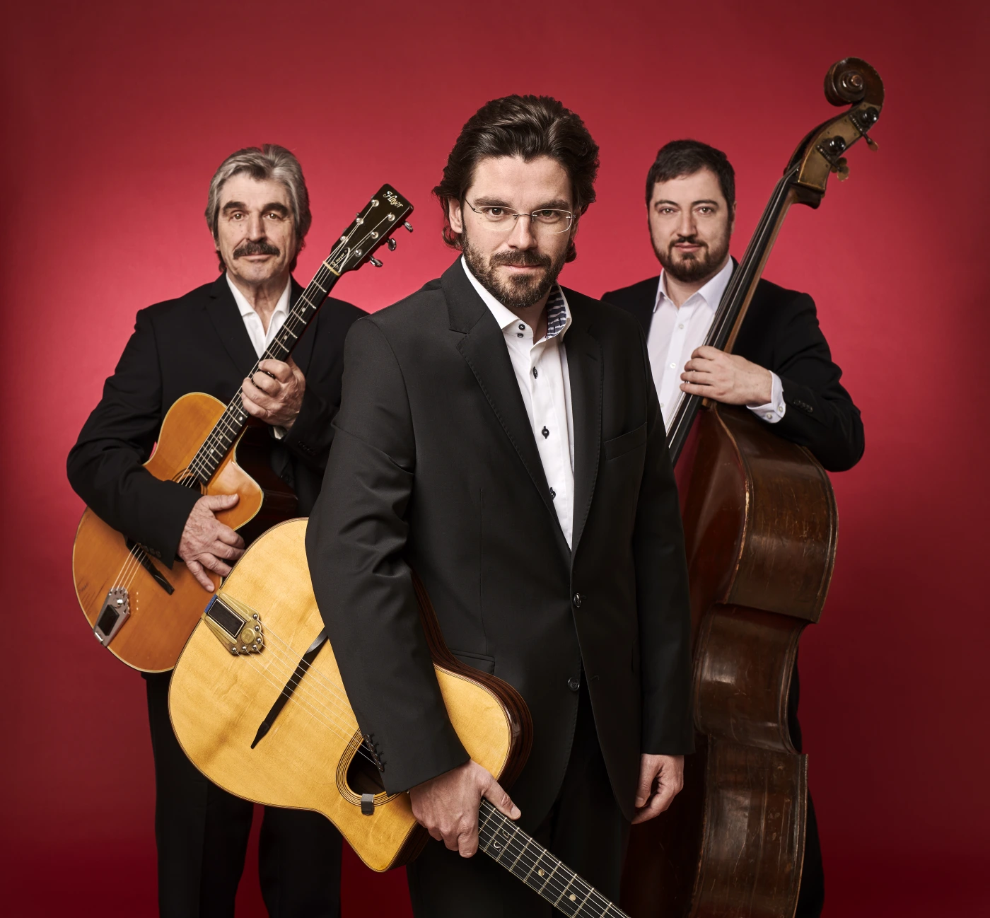 Three-piece jazz band with guitars and double bass