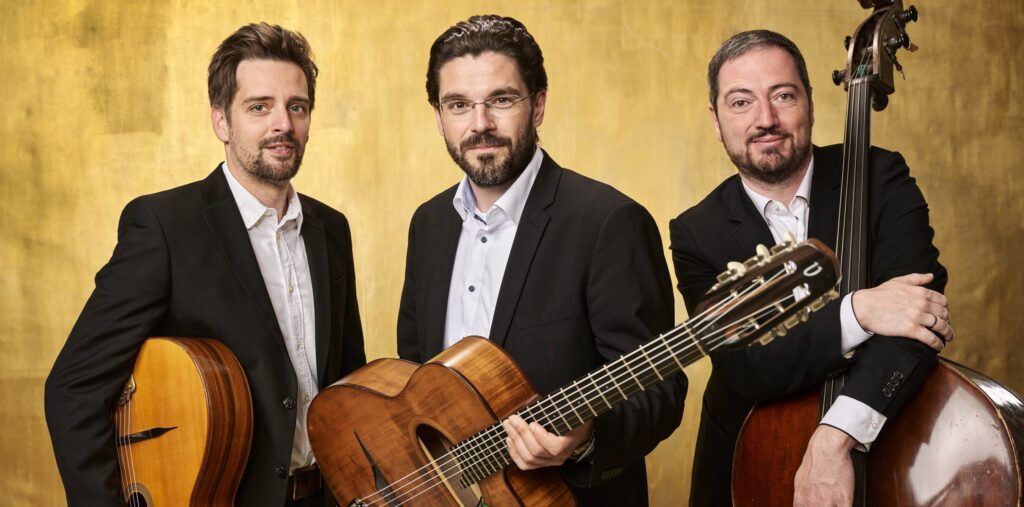 Three musicians in formal wear with acoustic instruments