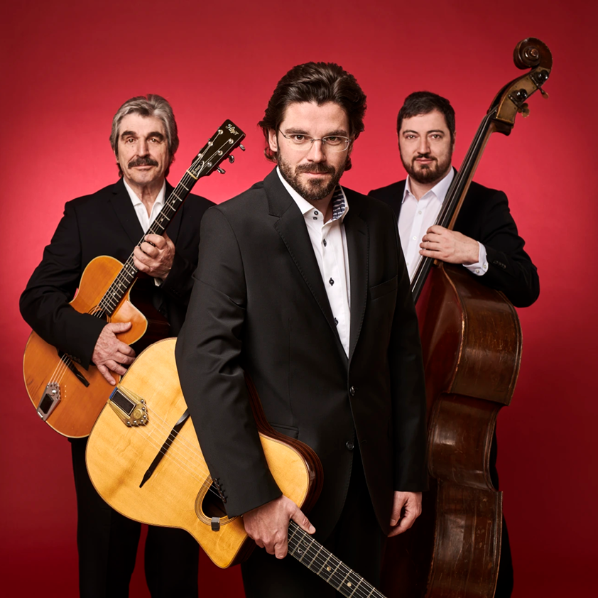 Three male musicians with guitars and double bass on red background