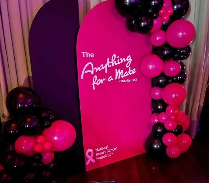 Anything for a Mate Charity Ball sign with pink balloons