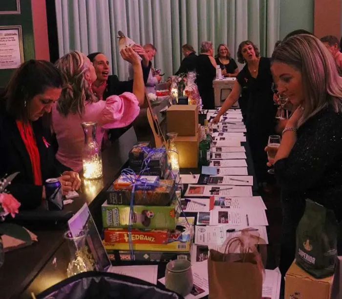 Guests browsing silent auction tables at charity gala event
