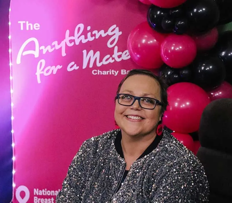 Smiling woman at Anything for a Mate charity ball event