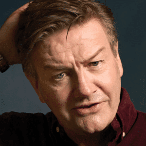 Middle-aged man with quizzical expression scratching his head
