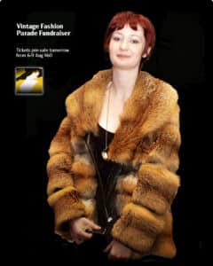 Red-haired woman in vintage fur coat at fashion fundraiser