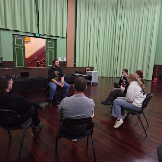Small group of people sitting in a circle discussion