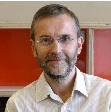 Middle-aged man with glasses and beard smiling