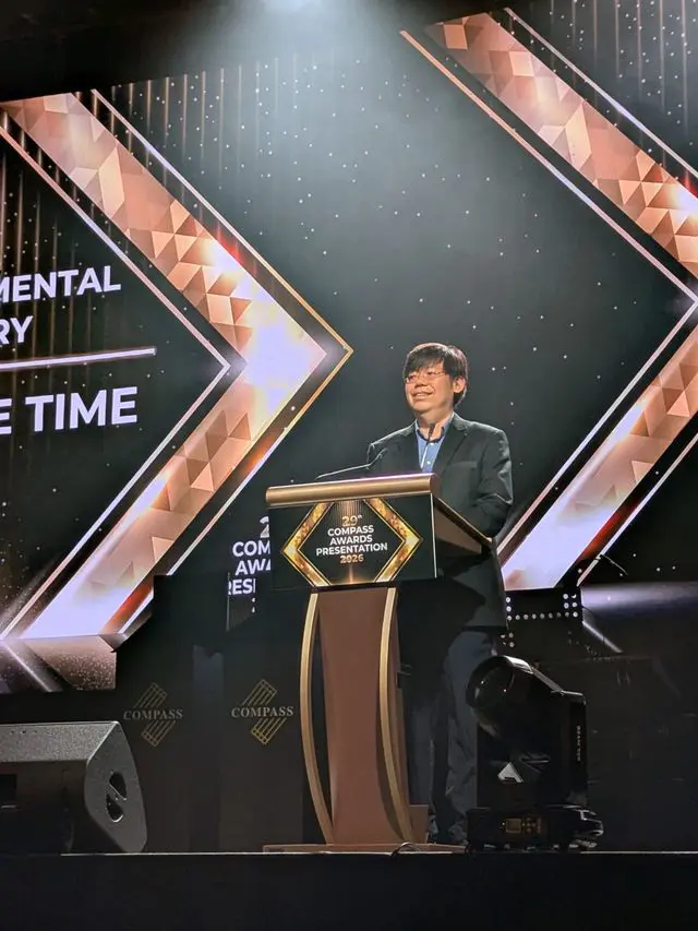 Man speaking at podium during Compass Awards Presentation ceremony