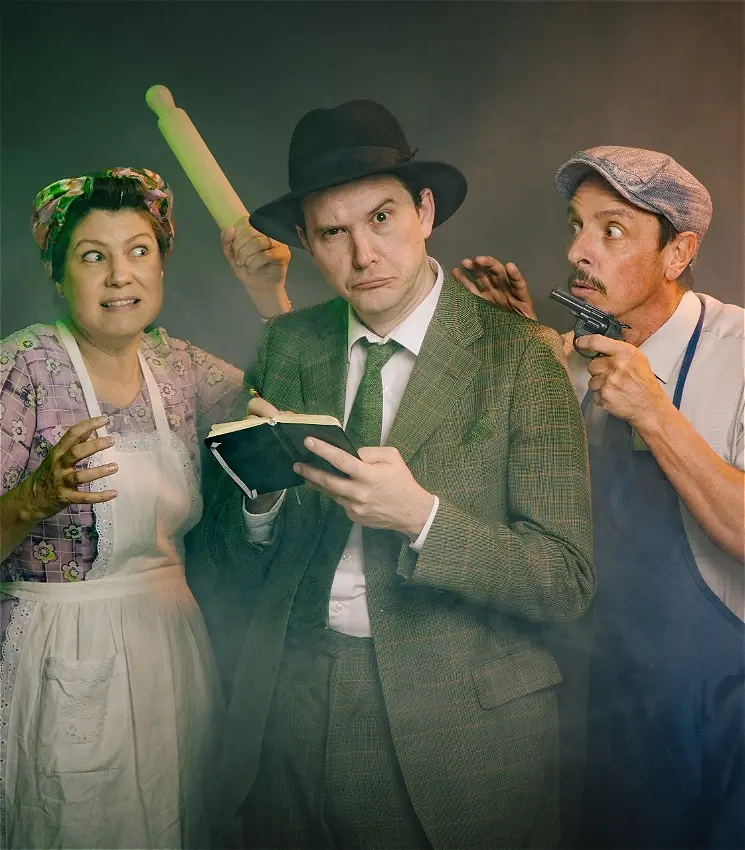 Three theatrical actors in costume with rolling pin and gun