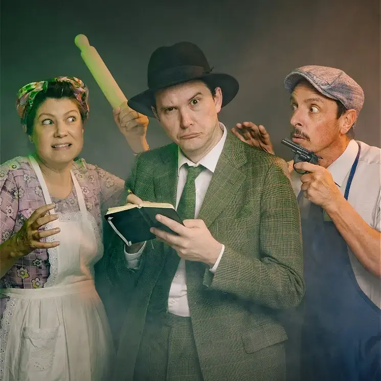 Three theatrical performers in costume with props in dramatic pose