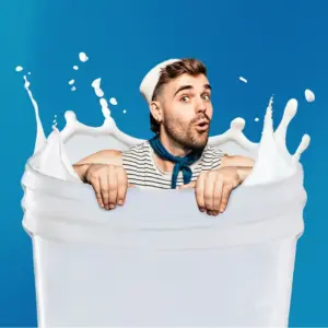 Man in sailor outfit emerging from giant milk glass splash